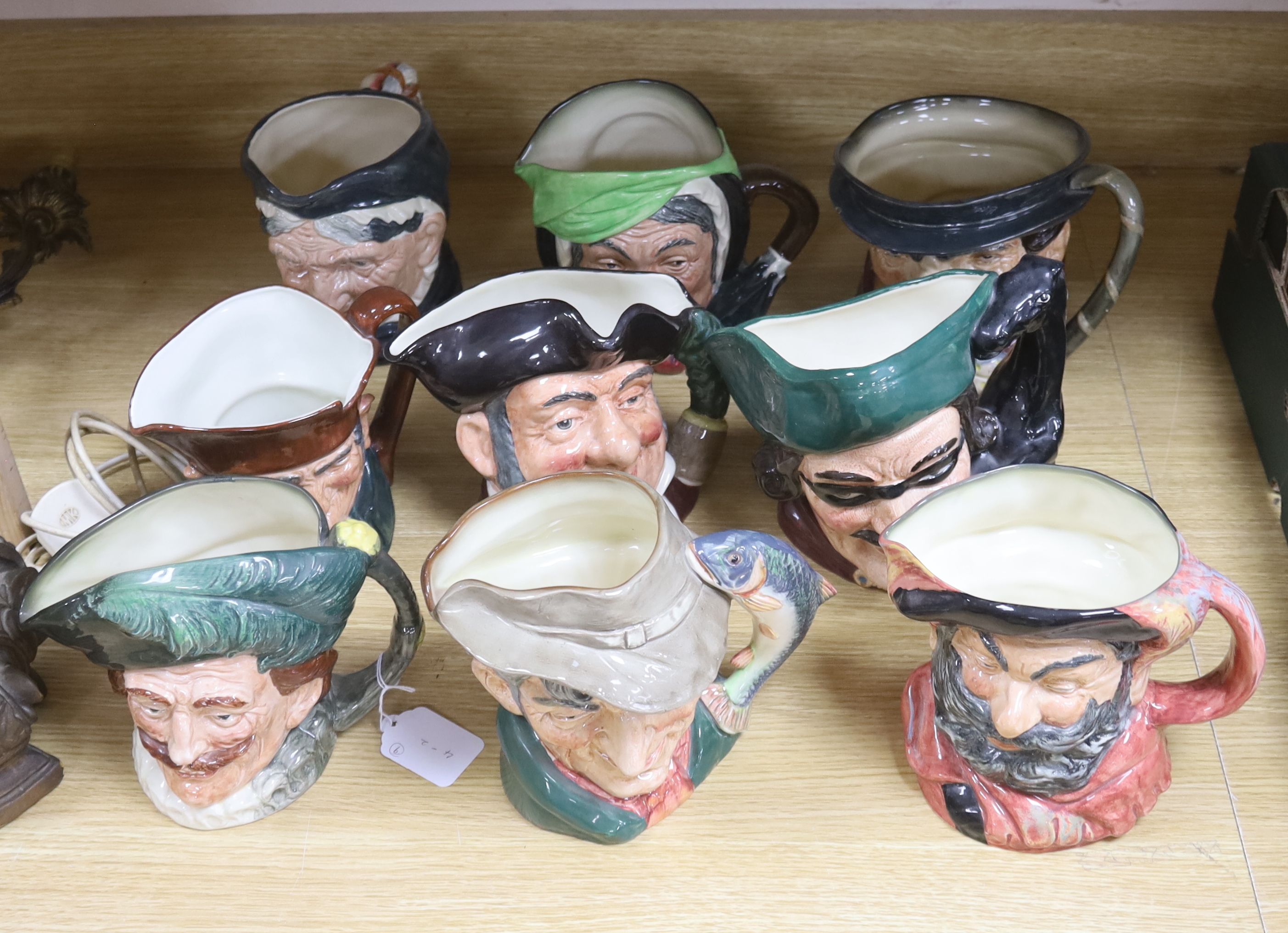 A large collection of nine Royal Doulton character jugs including Falsestaff, The Poacher, Old Charley, Mine Host, Dick Turpin, Granny and three others